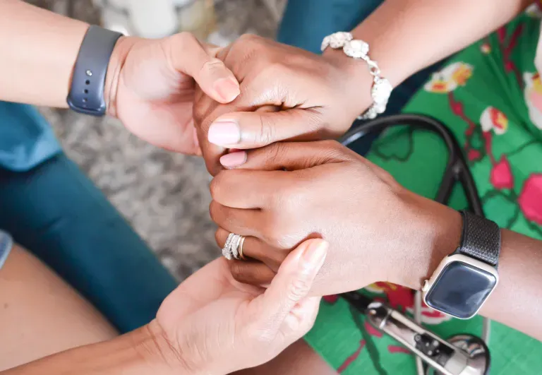 Hands joined together in support